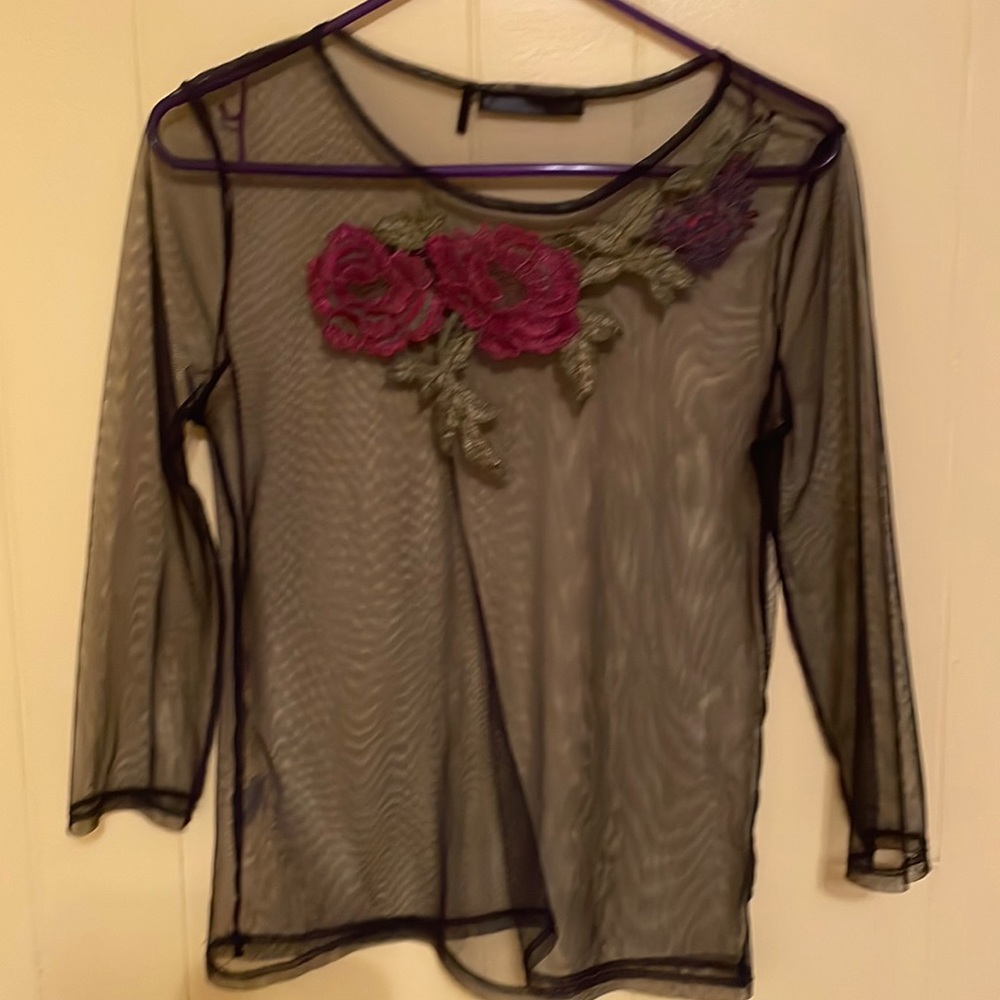 Net style blouse with pink and purple embroidery.